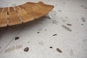 Terrazzo design with river stones and brass leaves embedded. 
