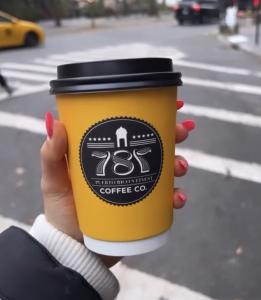 caffeinated human of new york holding a 787 coffee cup