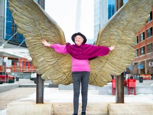 Arlene Rotter standing underneath angle wings