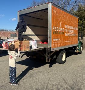 Student helping Load donations to Feeding Westchester! (Photo Credit: The chapel School / Michael Schultz)