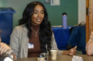 Melissa Hugh Speaks to a Table of Attendees at the 5th Black History Month Community Wellness Fair