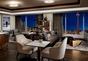Table for two on the hotel's high floor lounge with evening view of downtown Toronto skyline