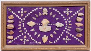 Framed display containing over 50 Paleo points and over 70 beads from the Southwestern U.S., mounted on purple velvet trade cloth, 15 inches by 27 inches. Estimate: $400-$600