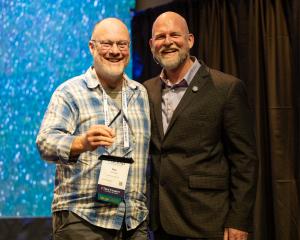 Photo of Ken Gossage, Executive Director of Good News at Noon, accepting Waypoint Award from James Whitford, Co-founder and CEO of True Charity