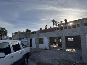 Iridium Development Inc. workers begin building elevated homes above existing structures to provide stronger flood protection and modernized living spaces