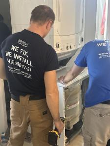 Working on repairing appliance