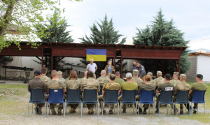 Ukrainian demining professionals attend an outdoor presentation at the MAT Kosovo training centre as they learn about International Mine Action Standards for Explosive Ordnance Destruction Level 3 examination expectations and certification requirements