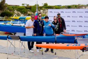 Individuals pose around some adaptive boats