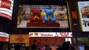 Two preserved rose bears made of red and blue roses with yellow initials “A” and “K” displayed in a boutique-style background.