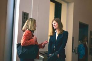 Two women (Alison Krentel and Cindy Termorshuizen), dressed in business attire stand and chat at the C7 Summit in Ottawa, Canada, April 15th, 2025