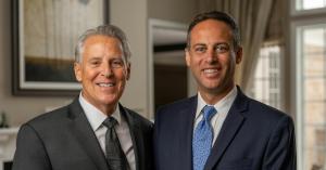 Two attorneys standing, smiling at the camera