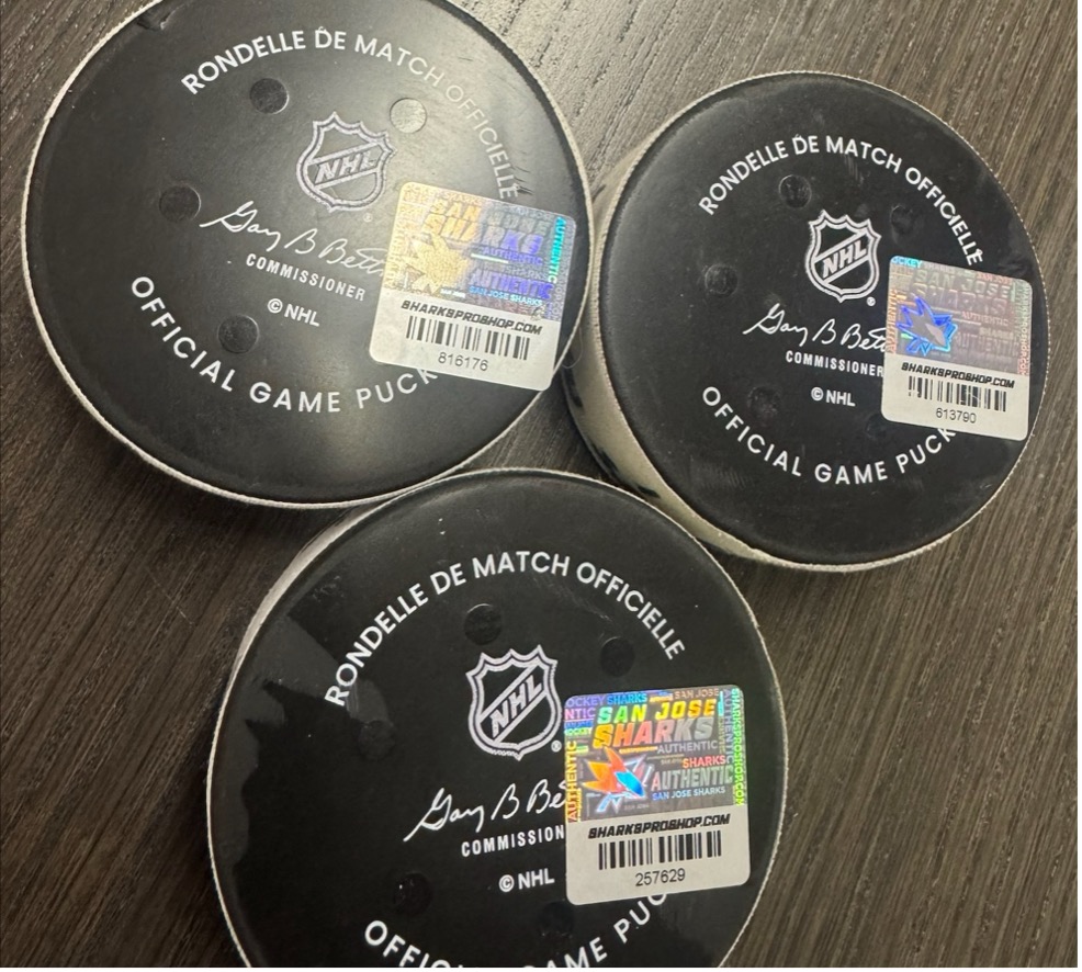 Three pucks with hologram labels on a tabletop
