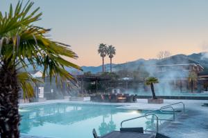 mineral spring pools with steam rising from them in early morning