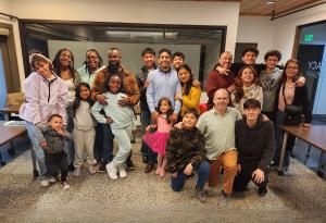 A Parents Challenge gathering features families arm in arm.