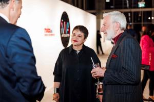 Dr Lourdes Ramos and Dr Robert BRaun talking with guests at the opening