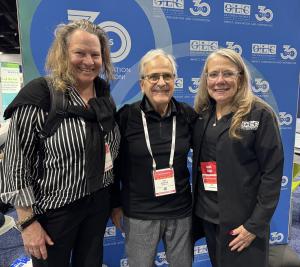 Three people in front of OLC logo background -- Mary Noyes, Ronald A. Sandler, Esq., and Lise Puckorius, CAE