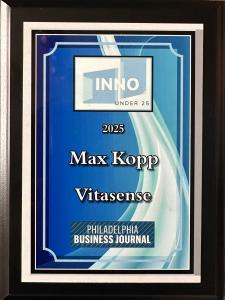 A framed blue and white plaque reading “INNO Under 25 2025 Max Kopp Vitasense Philadelphia Business Journal.”