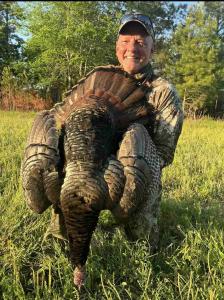 Turkey hunter and their trophy at Gray Ghost Plantation
