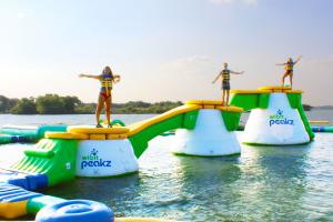 Kids posing on the floating Peakz Aqua Park at WhoaZone at Grapevine