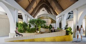 Wide-angle view of The Great Hall’s central bar area, with greenery and natural light enhancing the atmosphere of warmth and connection.