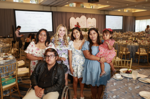 Olympic Gold Medalist, Tara Lipinski, and Miracles for Kids patient family recipient, Meranda Varela, seated at table