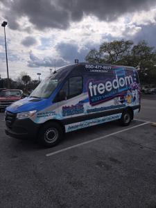 Freedom Wash Laundry's branded pickup and delivery van for the Pensacola area.
