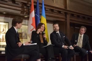 NATO Association of Canada panel with Her Excellency Yuliya Kovaliv, Ambassador of Ukraine to Canada, speaking and three other panelists, including NAOC CEO Robert Baines, listening intently