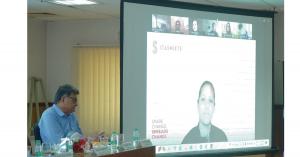 a woman - Mel Seigler, CEO of Stashlete, seen on a white screen delivering a speech virtually from USA during DDA's BallPark Inauguration event in India