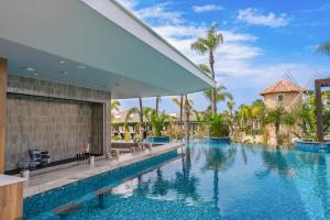 Inviting new adults-only Serenity Oasis Pool with sun-drenched loungers and tropical greenery