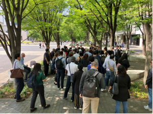 Group of businesspeople outside on a site tour of Yokohama's Minato Mirai 21 district