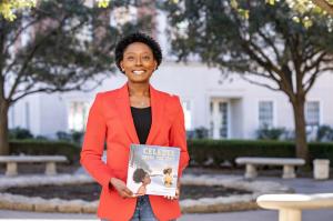 Author Courtney Kelly holding her book Celeste Saves the City