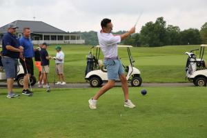 Man swinging golf club at Erney Tourney charity golf outing for AngelWorks