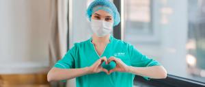 YTC healthcare Nurse wearing mask and making a heart shape with hands