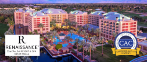 Aerial view of the Renaissance Esmeralda Resort & Spa in Indian Wells, featuring a pool and palm trees, with certification logos for autism support.