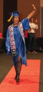 Photo of the only female graduate waiving to her family from the stage!