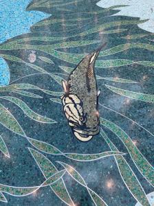 Swimming bass depicted in epoxy terrazzo design in the 2025 terrazzo Job of the year