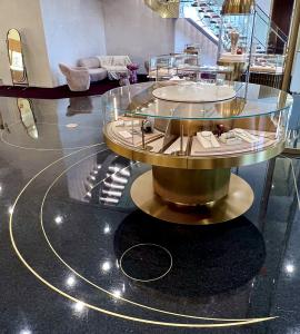 Terrazzo design: black terrazzo floor with decorative brass strips with jewelry display cases
