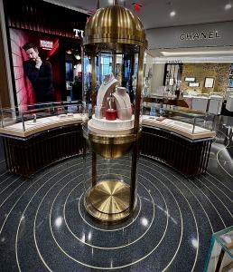 Terrazzo design: black terrazzo floor with decorative brass strips with jewelry display cases