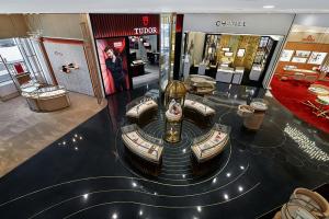 terrazzo design: black terrazzo floor with decorative brass strips with jewelry display cases