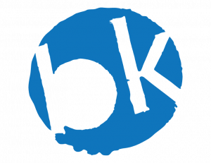 Logo of brooklynONE Productions: a stylized lowercase “b” and uppercase “K” inside a blue circle, representing the Brooklyn-based theatre company.