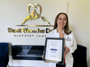 Dr. Radwa Saad, national speaker and The Wonder Tooth podcast Host holding a Top NJ Dentist for 2025 plaque