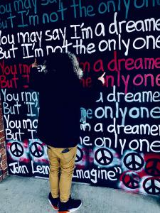 Matt Movin' a Chattanooga, Tennessee artist poses in front of a painted wall