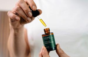 Minimalist skincare scene with THE 3 DROPS face oil in a clean, modern setting.