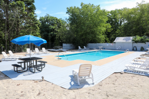 Large outdoor pool with umbrella and lounge chairs