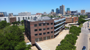 Aerial view of 1612 Summit Avenue office building in Fort Worth, showing four-story mid-rise structure and surrounding streets.