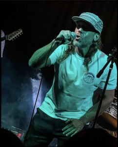 Lead singer of VBDC Seth Caro singing on stage