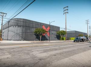 Street view of the X Buildings studio campus in Burbank, featuring black exterior walls and a red “X” logo.