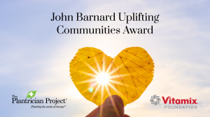 John Barnard Uplifting Communities Award Image in text over a blue sky with a hand holding up a yellow leaf with a sun behind it. The Plantrician Project Logo is to the left with a green leaf, and Vitamix Foundation logo is on the bottom right with "Vitam