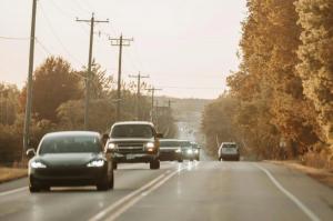 Image of cars driving along a rural highway.