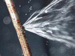 burst flexi hose pipe spraying water image